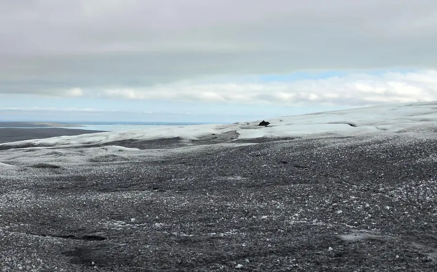 A guided group walking on Vatnajökull glacier above Jökulsárlón lagoon